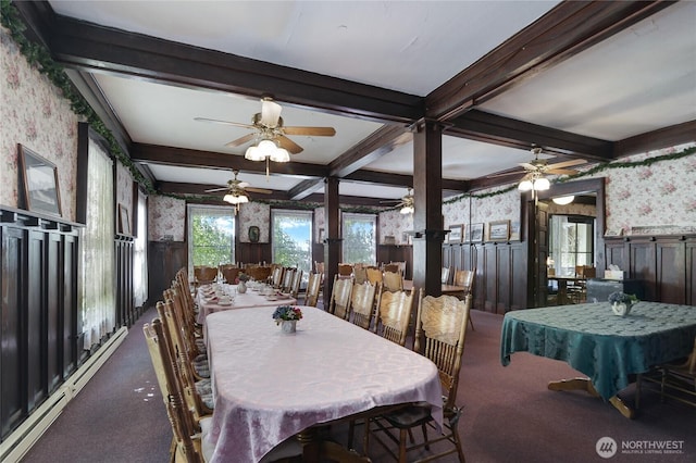 carpeted dining space featuring a wainscoted wall, wallpapered walls, beam ceiling, a sunroom, and a baseboard heating unit