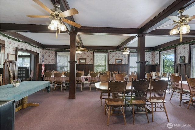 dining room with beamed ceiling, a healthy amount of sunlight, and wallpapered walls