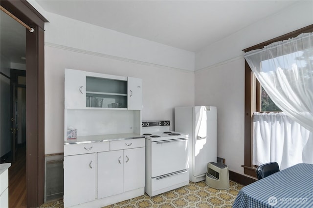 kitchen featuring light floors, light countertops, white appliances, white cabinetry, and open shelves