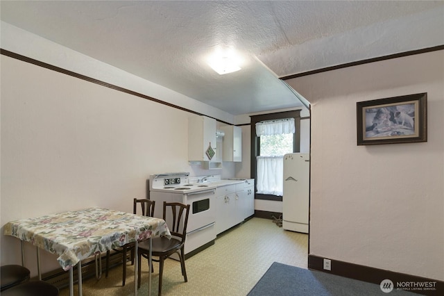 kitchen with electric stove, a textured ceiling, refrigerator, white cabinets, and light floors