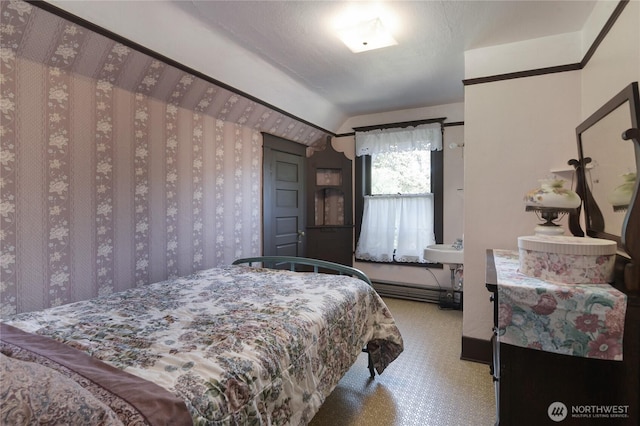 bedroom with carpet flooring, baseboard heating, and lofted ceiling