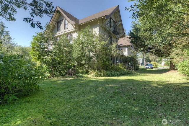 view of side of home with a lawn