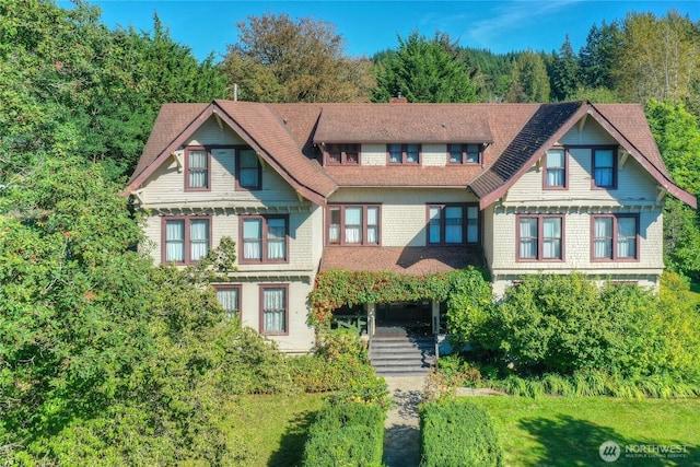 view of front of home featuring a chimney