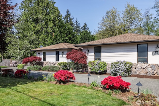 view of front of home with a front lawn and fence