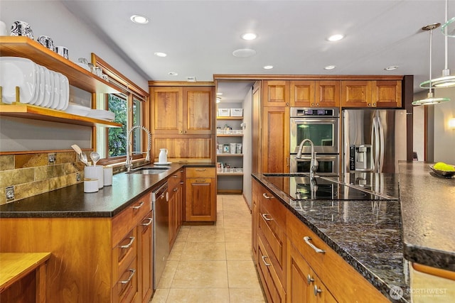 kitchen with brown cabinets, open shelves, a sink, appliances with stainless steel finishes, and recessed lighting