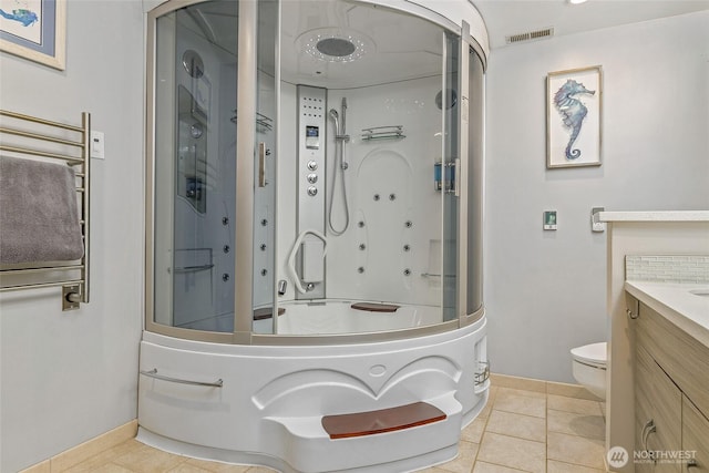 full bath featuring toilet, a shower with shower door, visible vents, and vanity