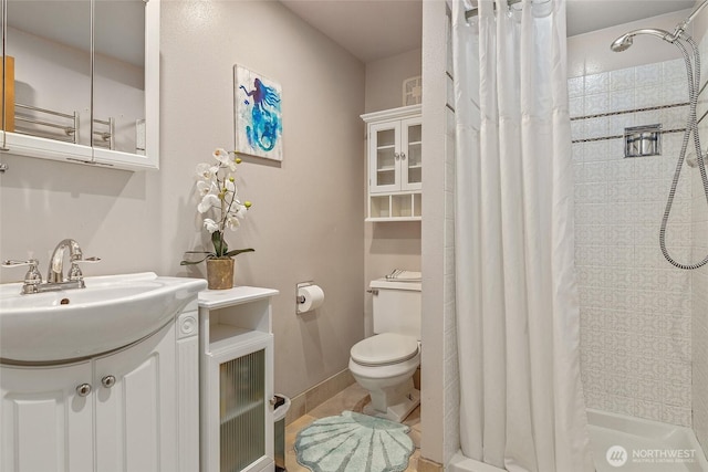 full bath featuring toilet, a stall shower, and vanity