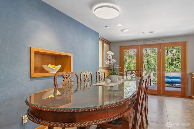 dining room featuring tile patterned flooring, visible vents, and french doors