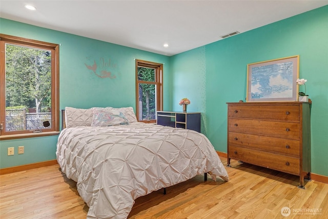bedroom featuring visible vents, wood finished floors, and baseboards