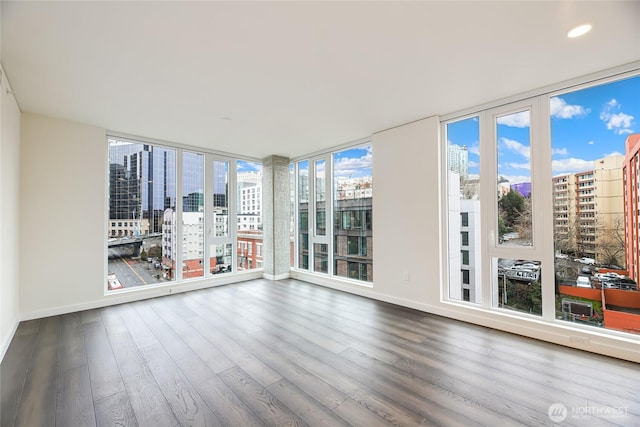 unfurnished sunroom featuring a view of city and plenty of natural light