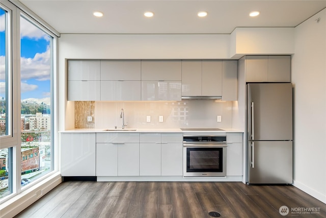 kitchen featuring appliances with stainless steel finishes, modern cabinets, light countertops, and gray cabinetry