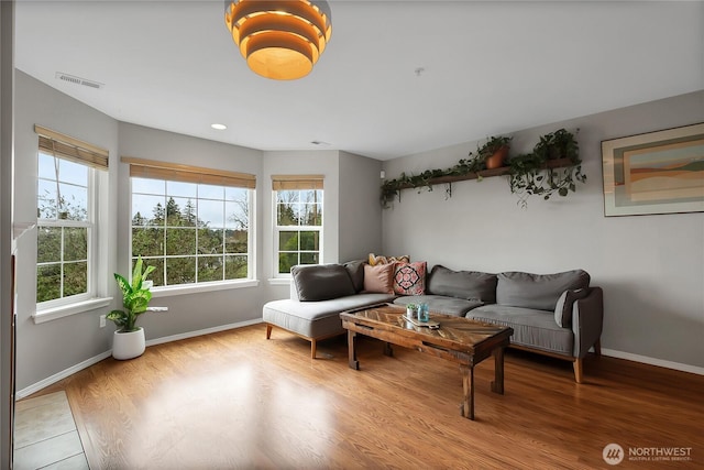 living room featuring recessed lighting, visible vents, baseboards, and wood finished floors