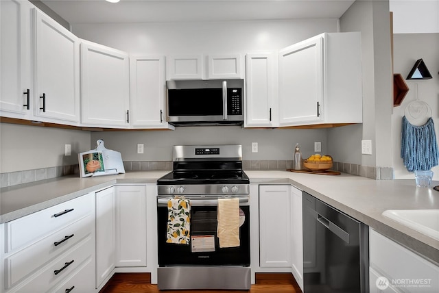 kitchen featuring light countertops, white cabinets, and stainless steel appliances