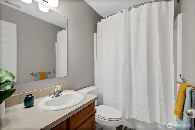 bathroom with visible vents, toilet, and vanity