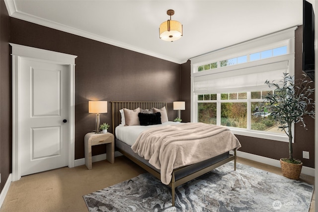 bedroom featuring baseboards, light carpet, and crown molding