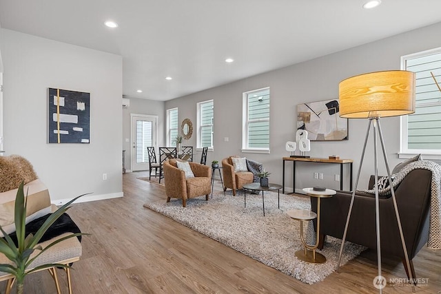 living room with recessed lighting, wood finished floors, and baseboards