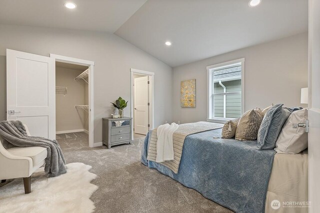 carpeted bedroom featuring a walk in closet, baseboards, lofted ceiling, recessed lighting, and a closet