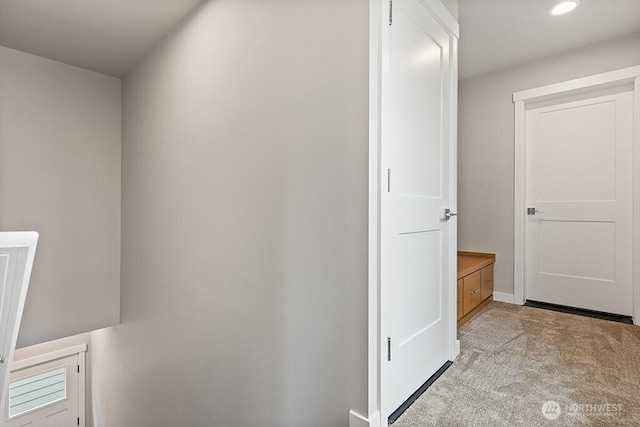 corridor with recessed lighting and light carpet