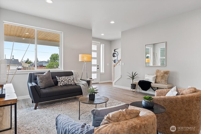 living room with recessed lighting, baseboards, and wood finished floors