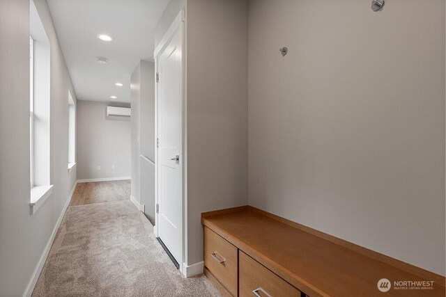 hall with recessed lighting, baseboards, light colored carpet, and a wall unit AC