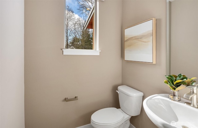 half bathroom with a sink and toilet