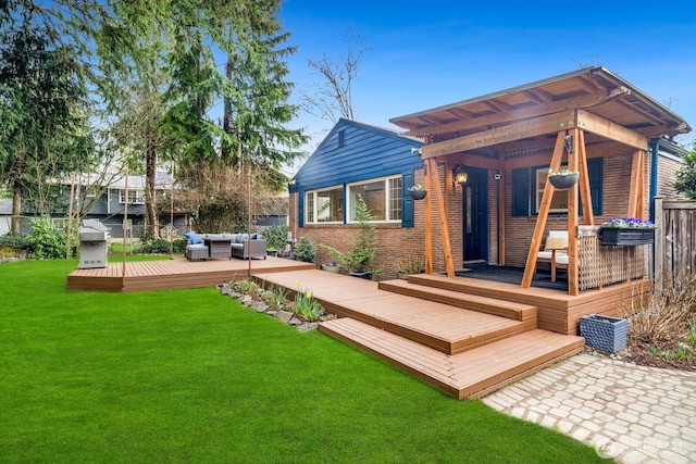 rear view of property featuring a wooden deck, a yard, brick siding, and an outdoor hangout area