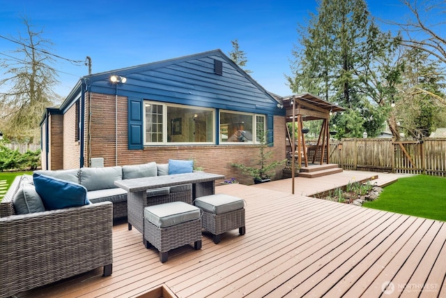 wooden deck with outdoor lounge area and fence