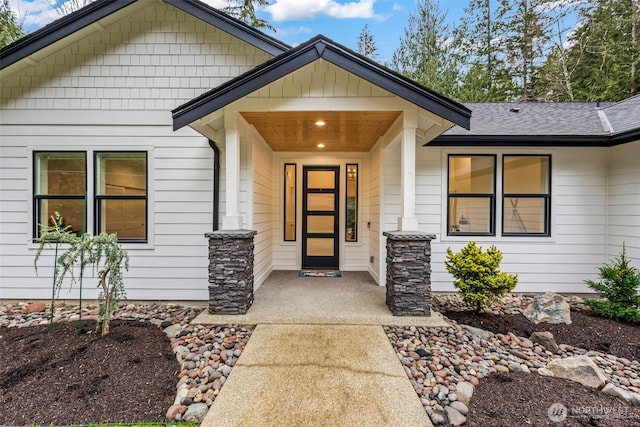 entrance to property with a shingled roof