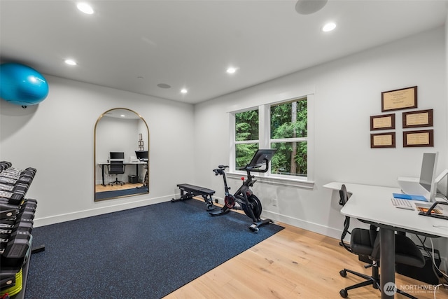 exercise area featuring recessed lighting, baseboards, and wood finished floors