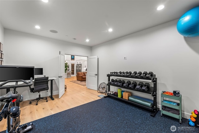 workout area with wood finished floors, recessed lighting, and baseboards