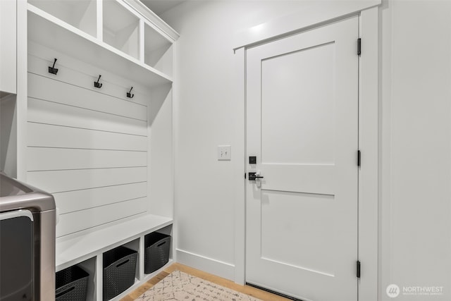 mudroom with light wood-style floors and washer / dryer