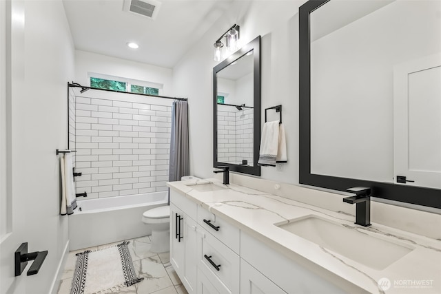 bathroom with a sink, visible vents, toilet, and marble finish floor