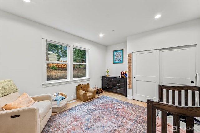 bedroom featuring a closet, recessed lighting, and light wood-style floors