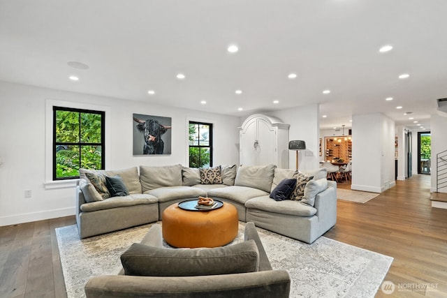 living area with recessed lighting, baseboards, and hardwood / wood-style floors