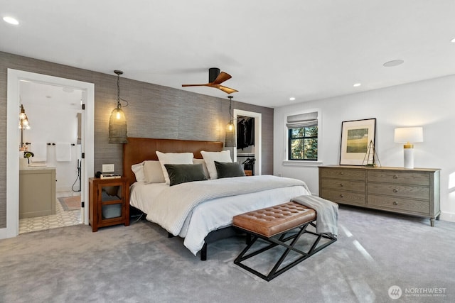 carpeted bedroom featuring recessed lighting, ceiling fan, a closet, ensuite bathroom, and a walk in closet