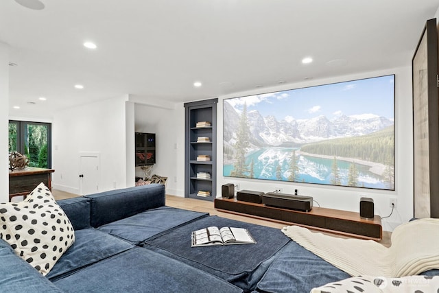 living room featuring recessed lighting, built in shelves, and wood finished floors