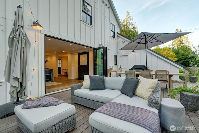 wooden deck featuring an outdoor living space, outdoor dining area, and grilling area