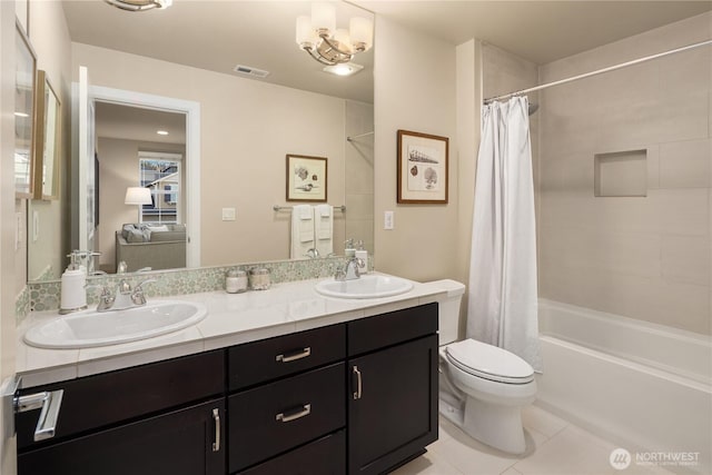 bathroom featuring tile patterned floors, visible vents, toilet, and a sink