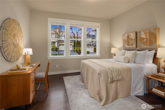 bedroom with baseboards and dark wood-style flooring