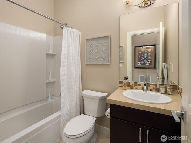 bathroom featuring tasteful backsplash, toilet, vanity, and shower / bath combo