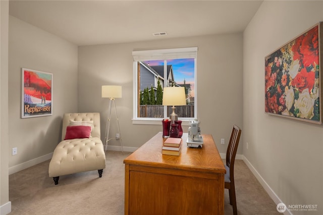 office space with visible vents, light colored carpet, and baseboards