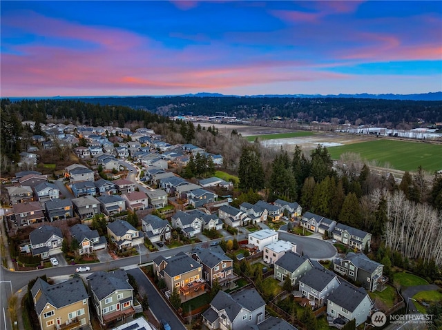 aerial view at dusk featuring a residential view