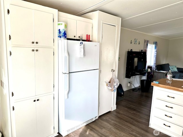 kitchen with open floor plan, white cabinetry, dark wood-style floors, and freestanding refrigerator