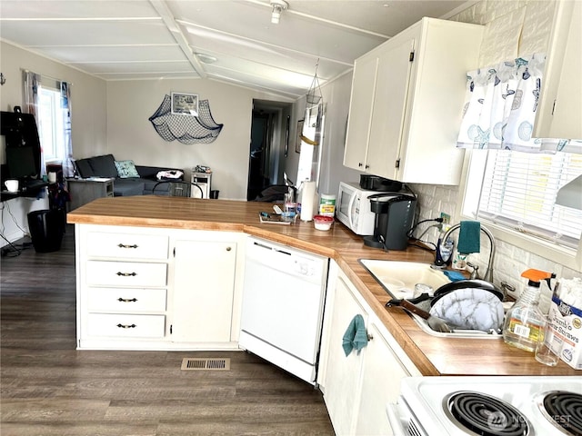 kitchen featuring white appliances, visible vents, dark wood finished floors, a peninsula, and wood counters