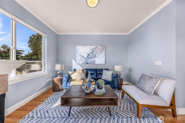 living room with wood finished floors, baseboards, and ornamental molding