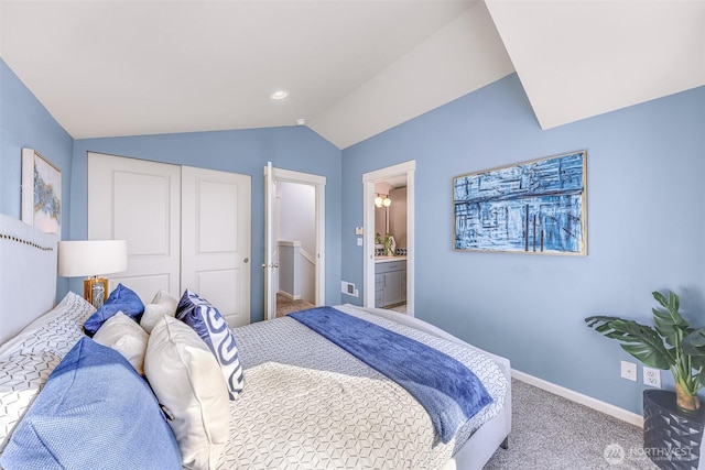 bedroom with baseboards, vaulted ceiling, a closet, carpet flooring, and connected bathroom