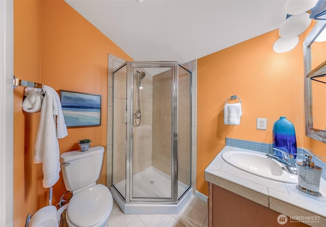 full bath with tile patterned flooring, vanity, a shower stall, and toilet