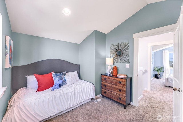 carpeted bedroom with vaulted ceiling, visible vents, and baseboards