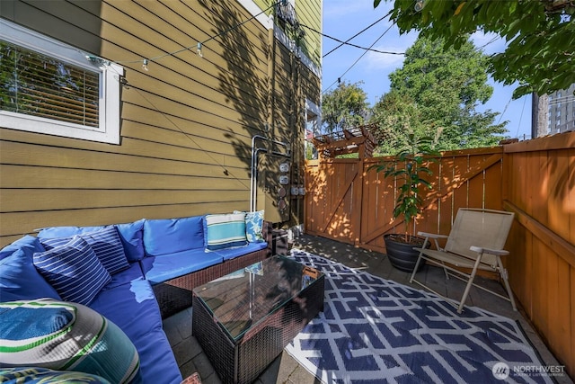 view of patio featuring an outdoor hangout area and fence