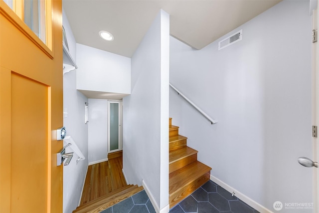 stairs with tile patterned flooring, baseboards, and visible vents